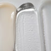Un gros plan montre les textures du sérum activateur LightBoost Wand de Solawaves : beige crémeux, gel transparent infusé de la technologie LightBoost et crème lisse gris clair/blanc. Les textures varient de crémeuse à gélifiée, chacune présentant un fini brillant.